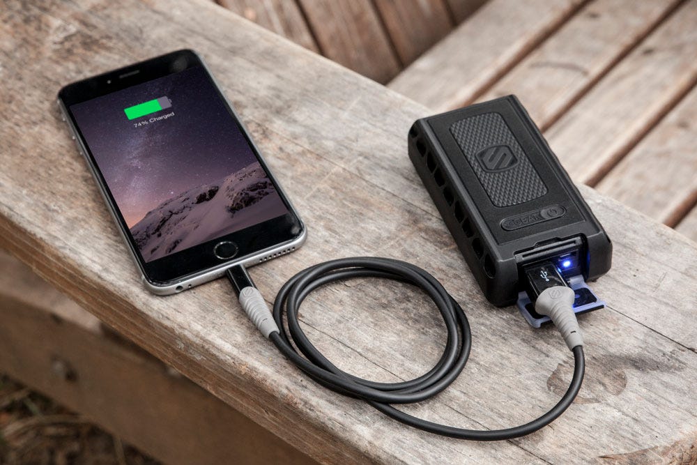 iphone charging via Scosche portable backup battery while sitting on wood bench
