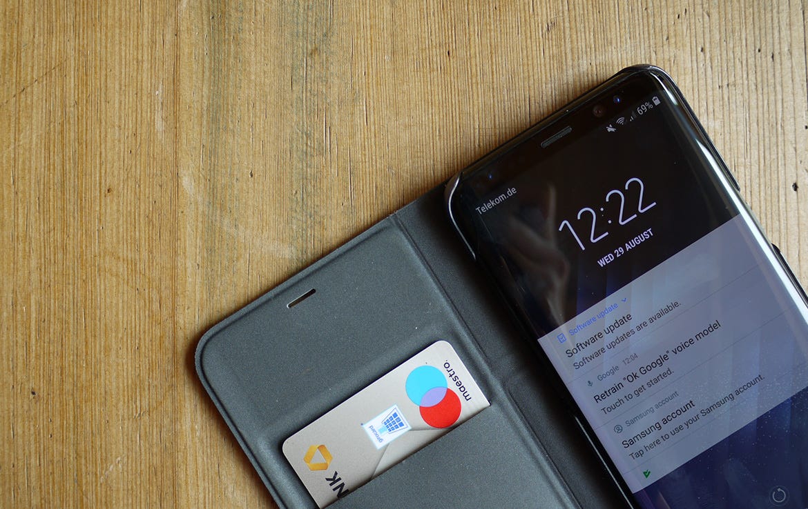 Samsung phone in wallet case on table
