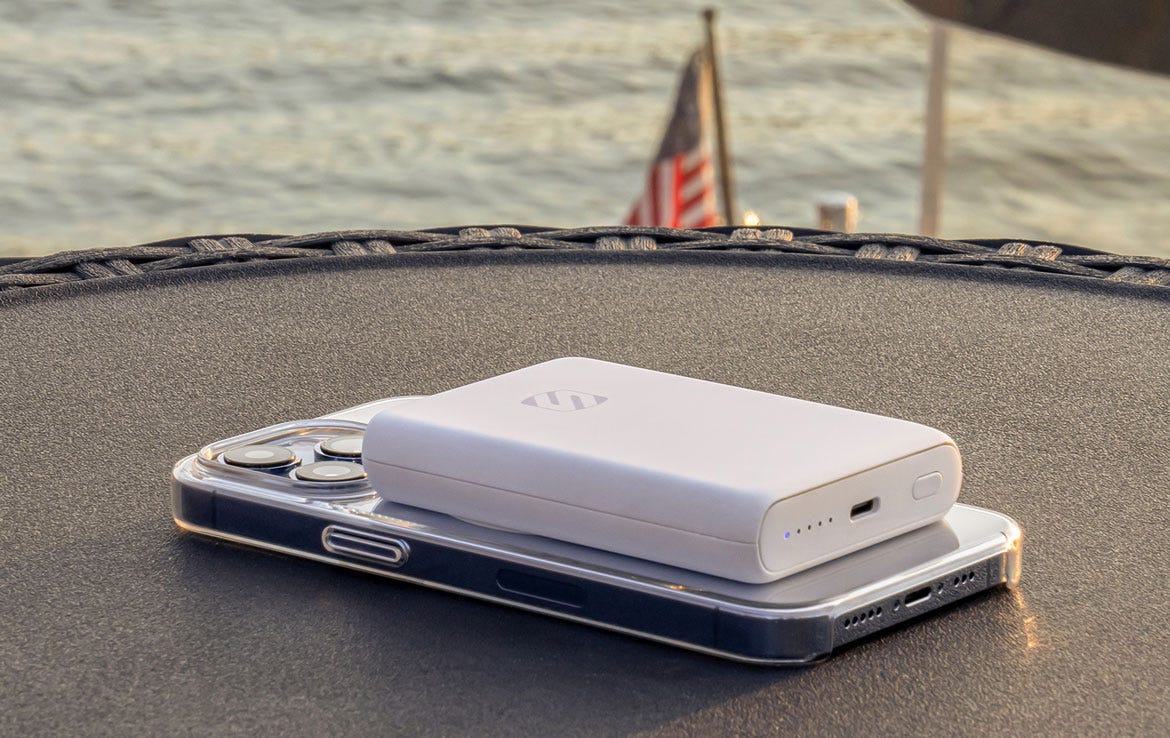 iphone charging via white power bank while sitting on table