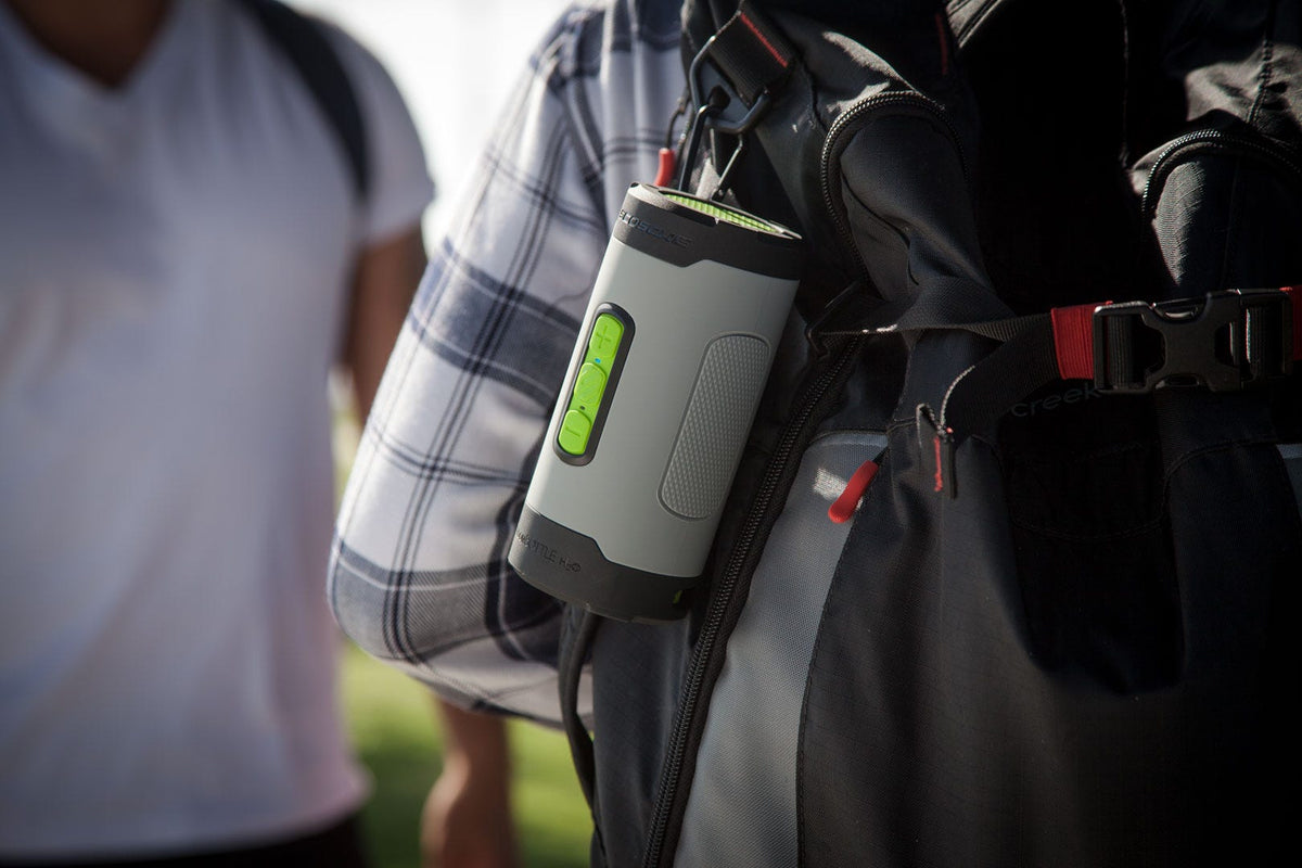Scosche waterproof Bluetooth speaker clipped to backpack
