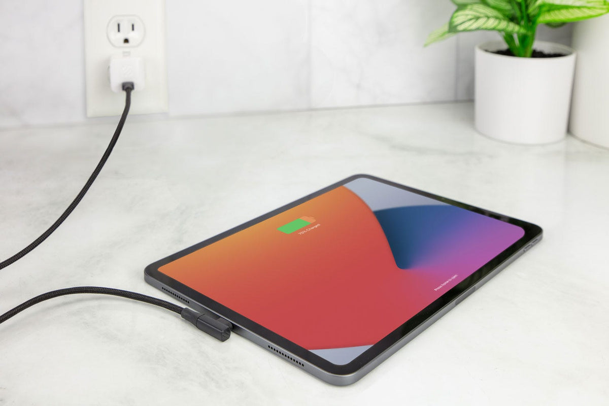 iPad with USB-C cable plugged into it and connected to a wall charger