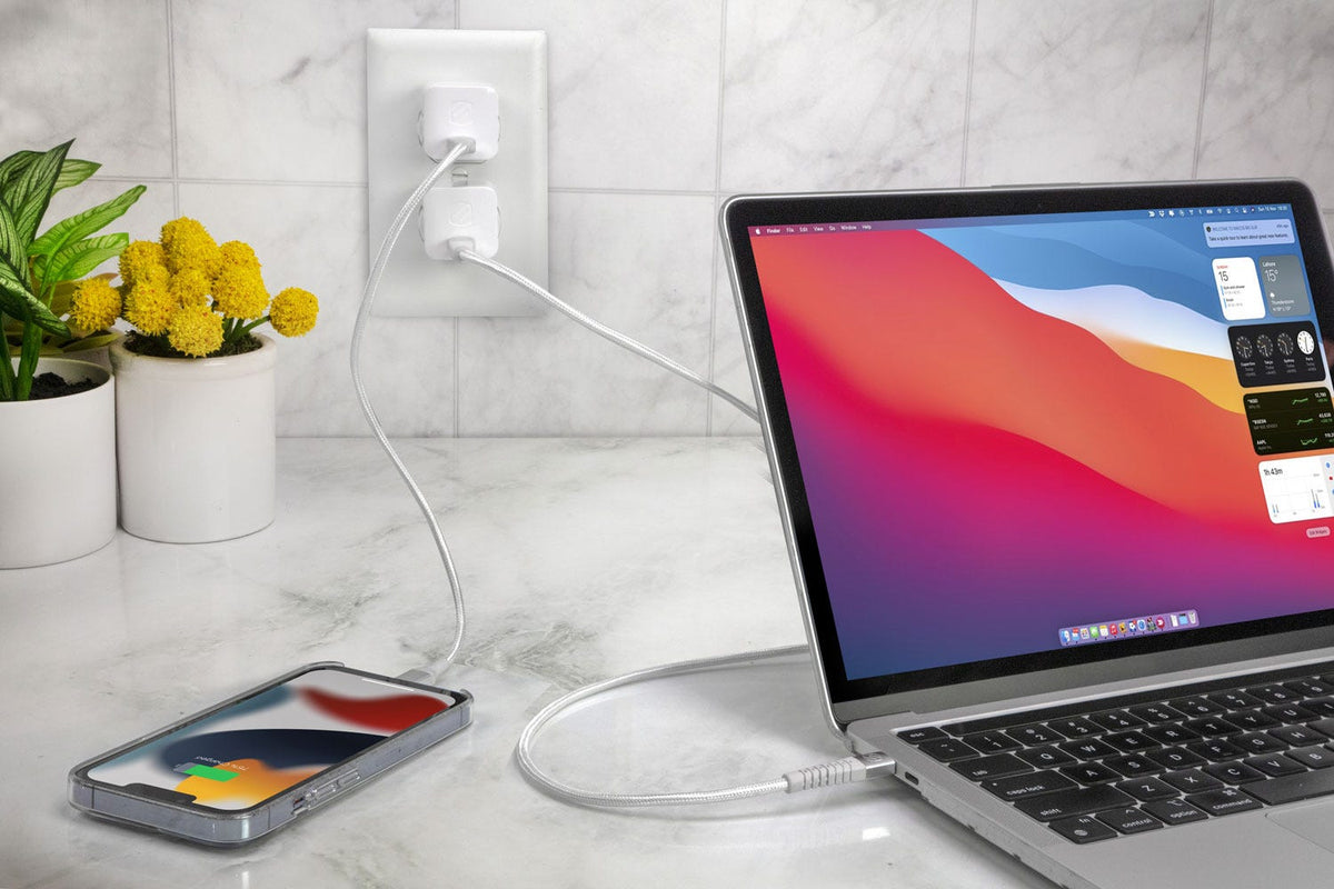 iphone and MacBook chargina via Scosche USB-C cables and wall charger while sitting on countertop