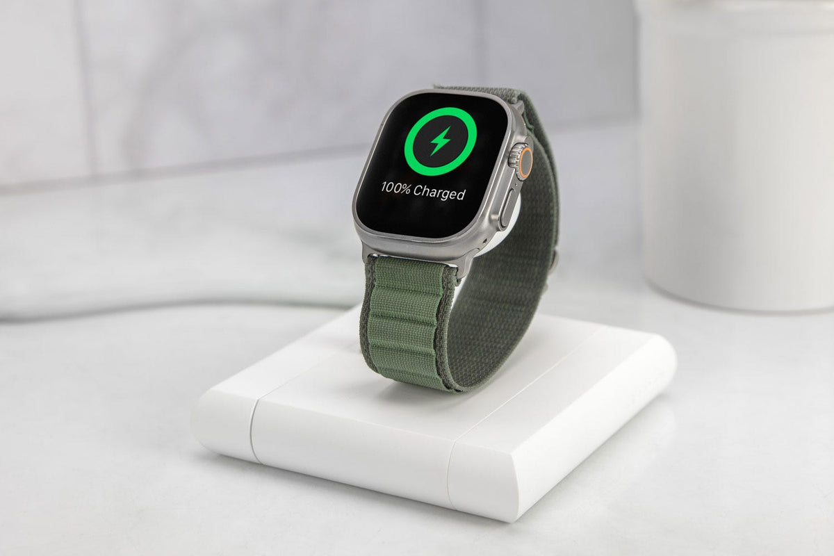 Apple Watch showing 100% charged sitting on Scosche apple watch wireless charging stand