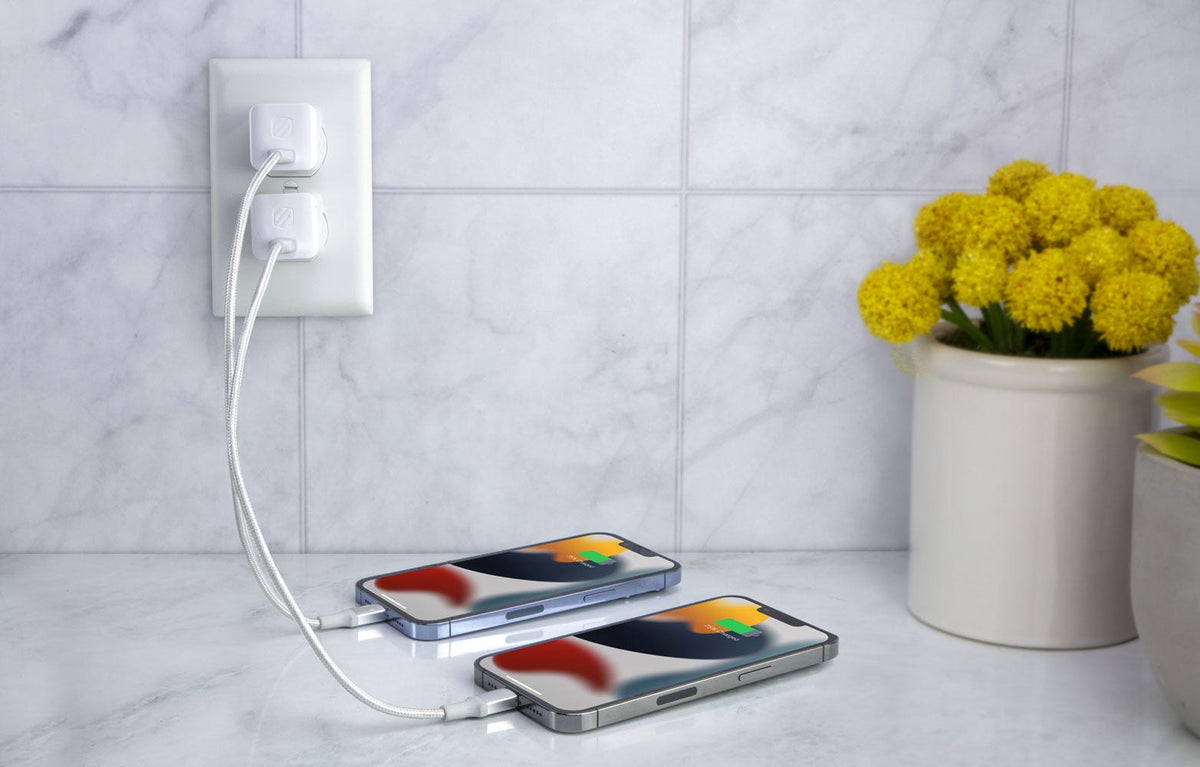 two iphones charging via Scosche wall charger and braided cables on countertop