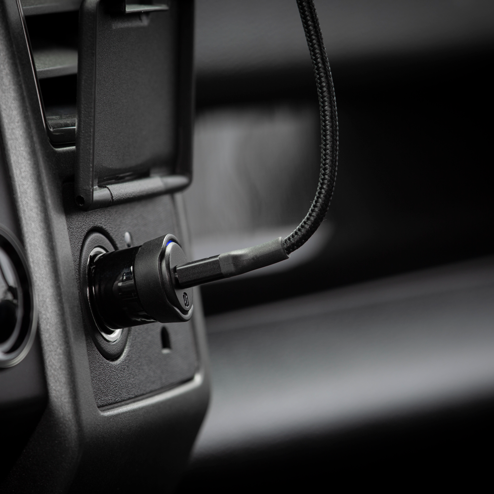 close up of Scosche car charger in vehicle outlet