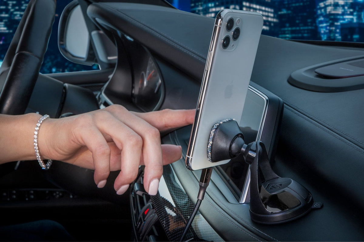 iphone mounted to car dash while woman pressed iphone screen
