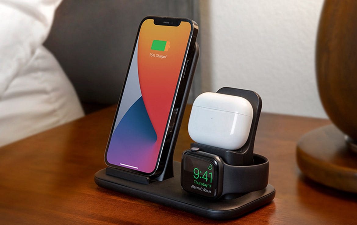 iPhone, Airpods and Apple watch charging on 3-in-1 wireless charging stand on bedside table