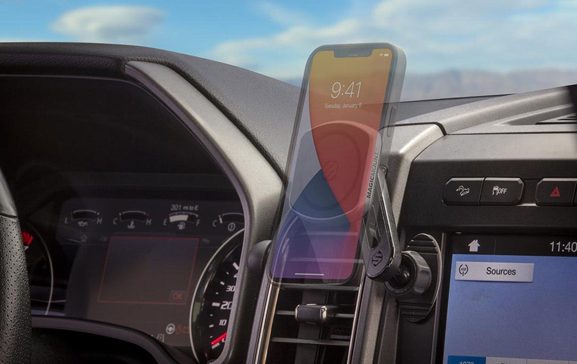 ghosted iphone mounted to swing-arm vent mount in car