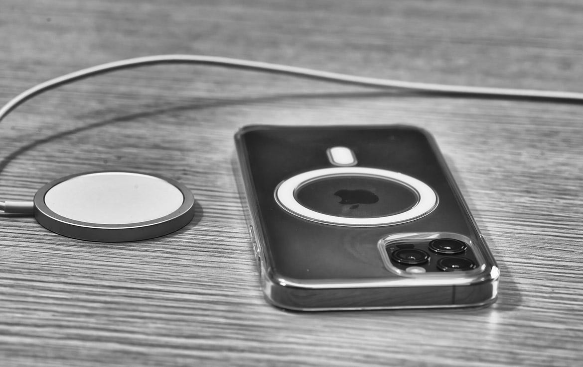 iphone with MagSafe case next to wireless charging puck