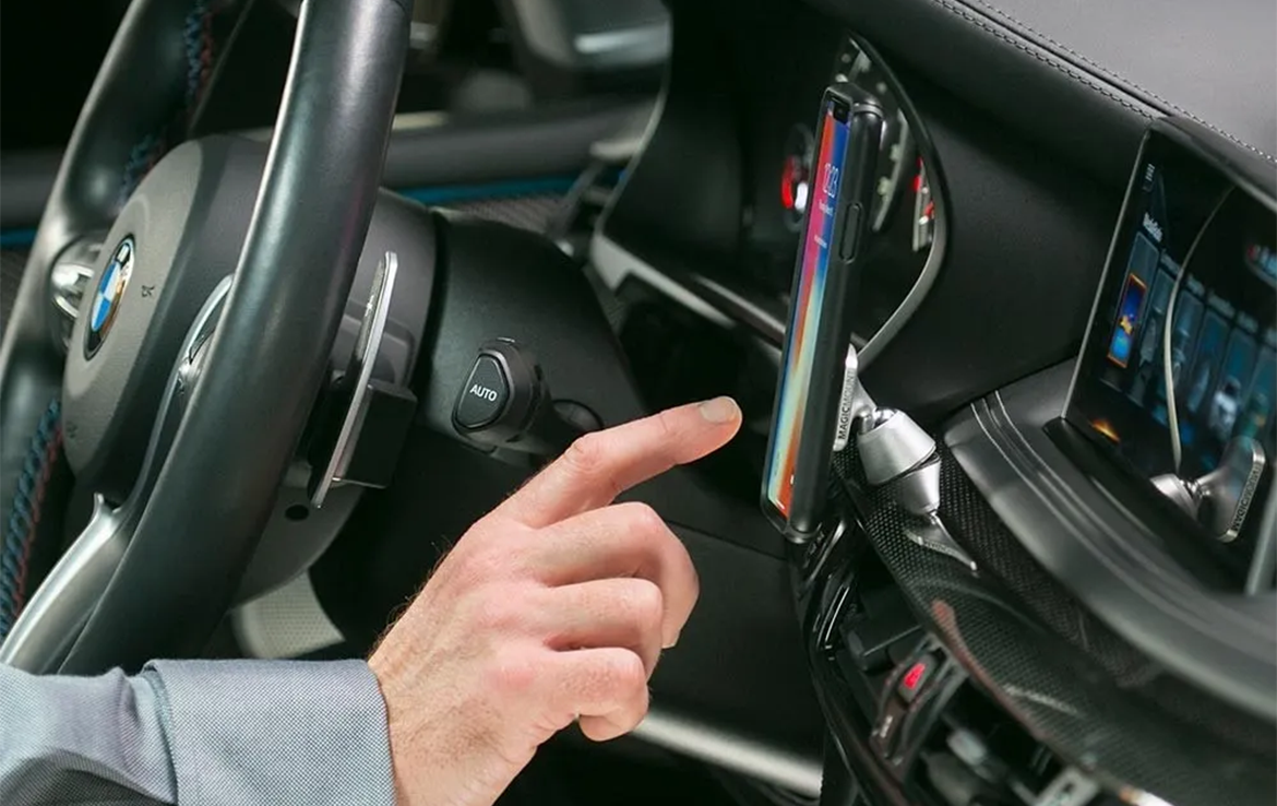 man using phone while mounted to car dash