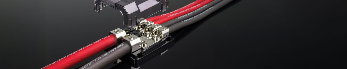 Electrical distribution block with two wires going in on the left side and four coming out on the right side