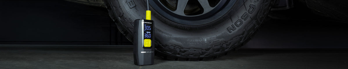 Tire inflator next to a large truck wheel