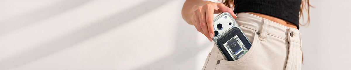 Woman putting phone with wallet attached into her front pocket