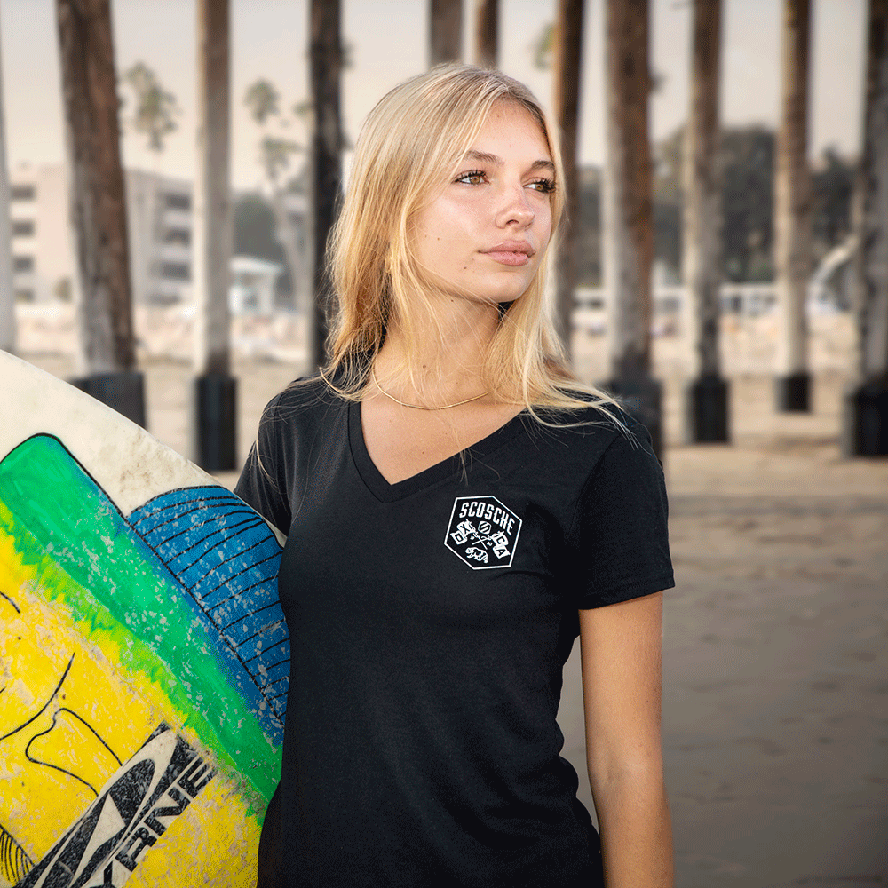 Woman with surfboard wearing Scosche Ladies' Tee with Bear Logo