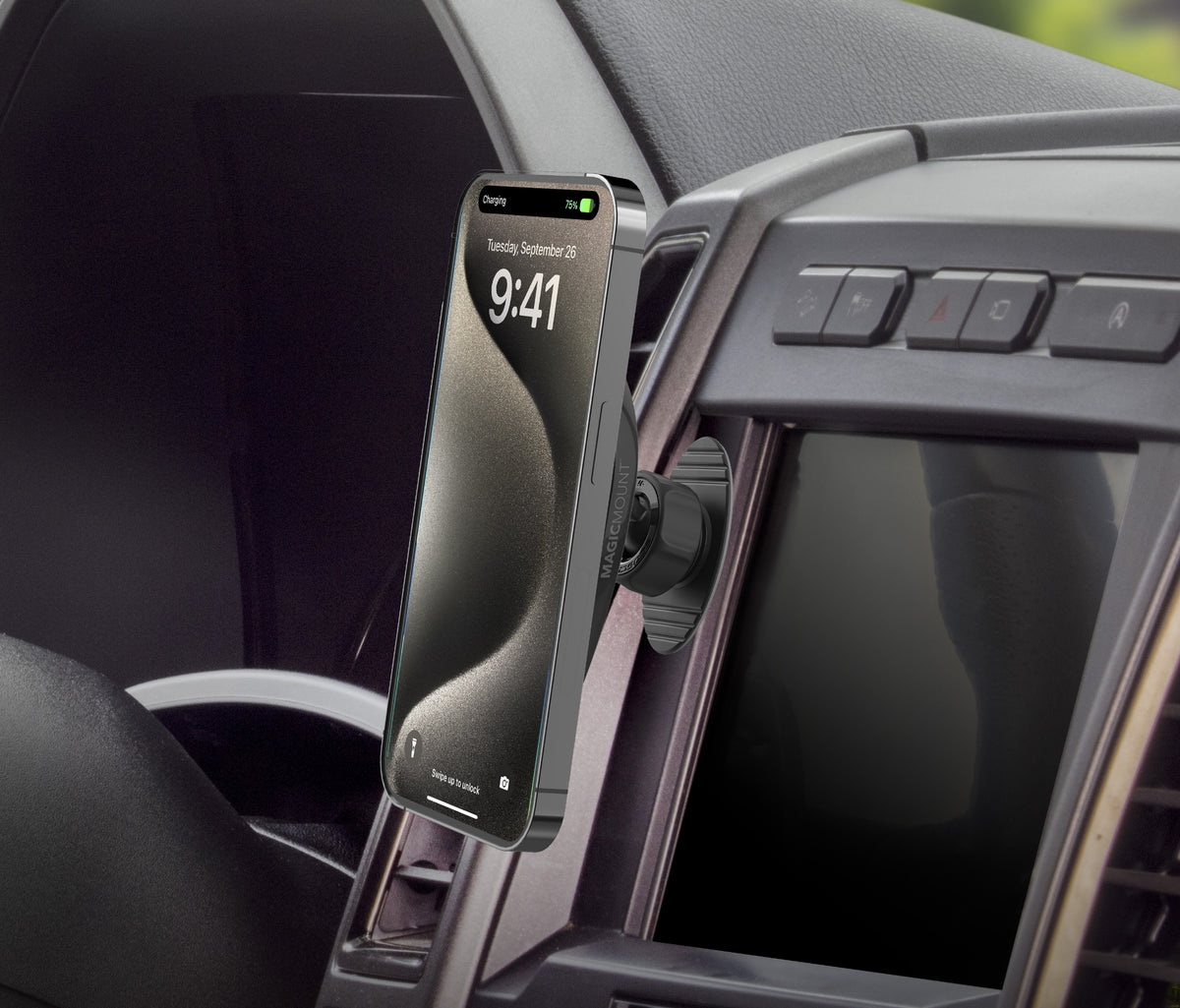 Image of the MagicMount Charge Dash/Vent on a vehicle dashboard, holding an iPhone