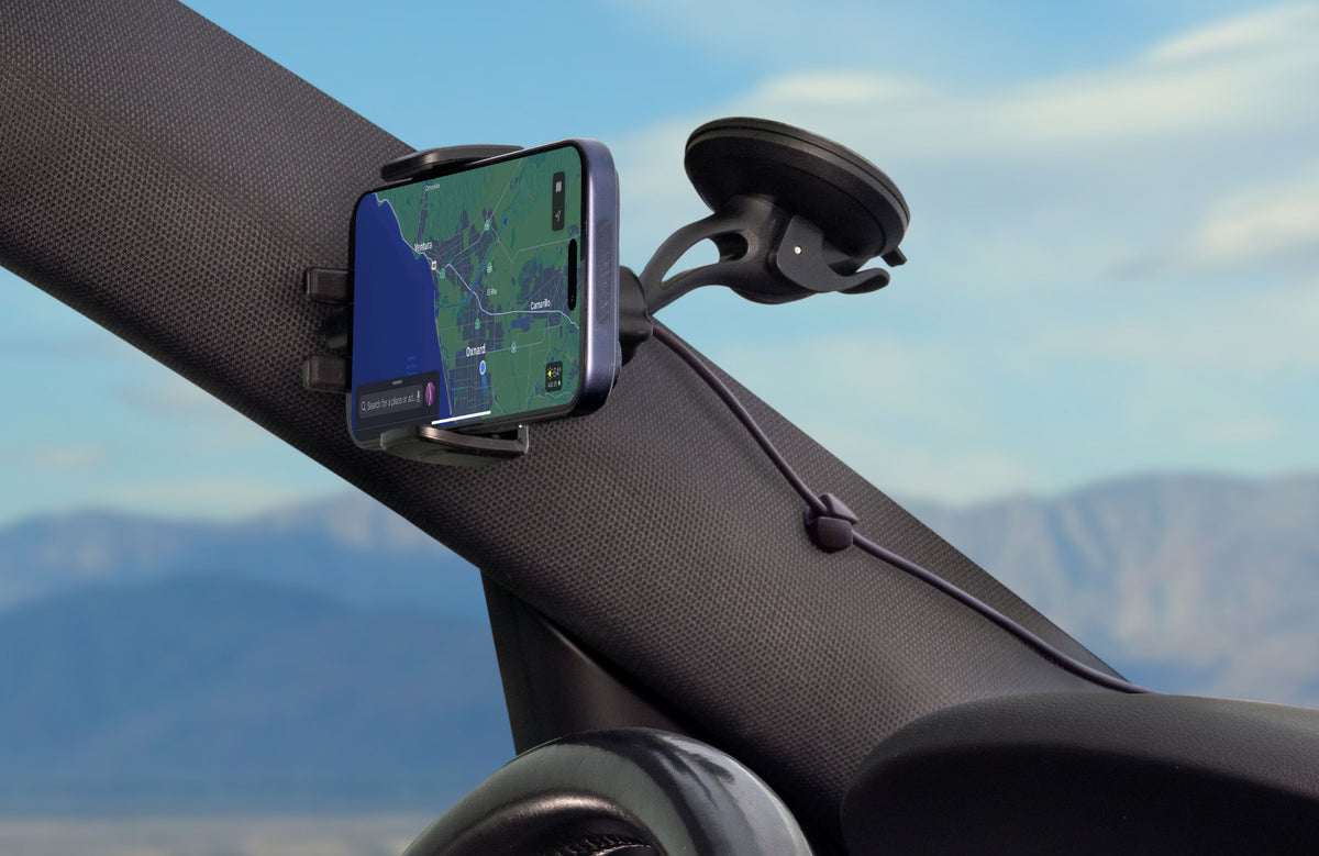Photo of a phone held by the MagicGrip Charge Dash/Window/Vent inside a vehicle