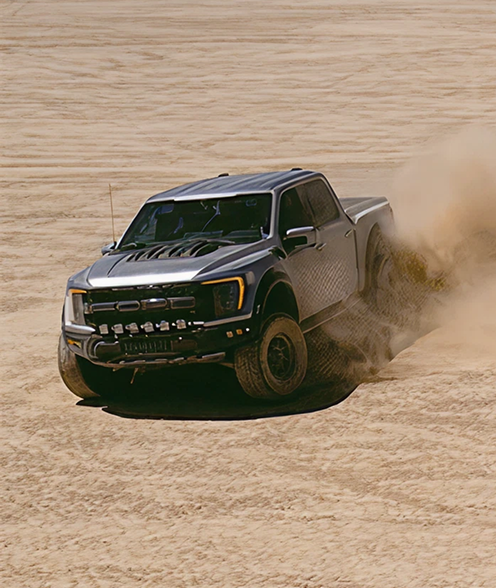 Ford F-150 Raptor driving off road in the desert