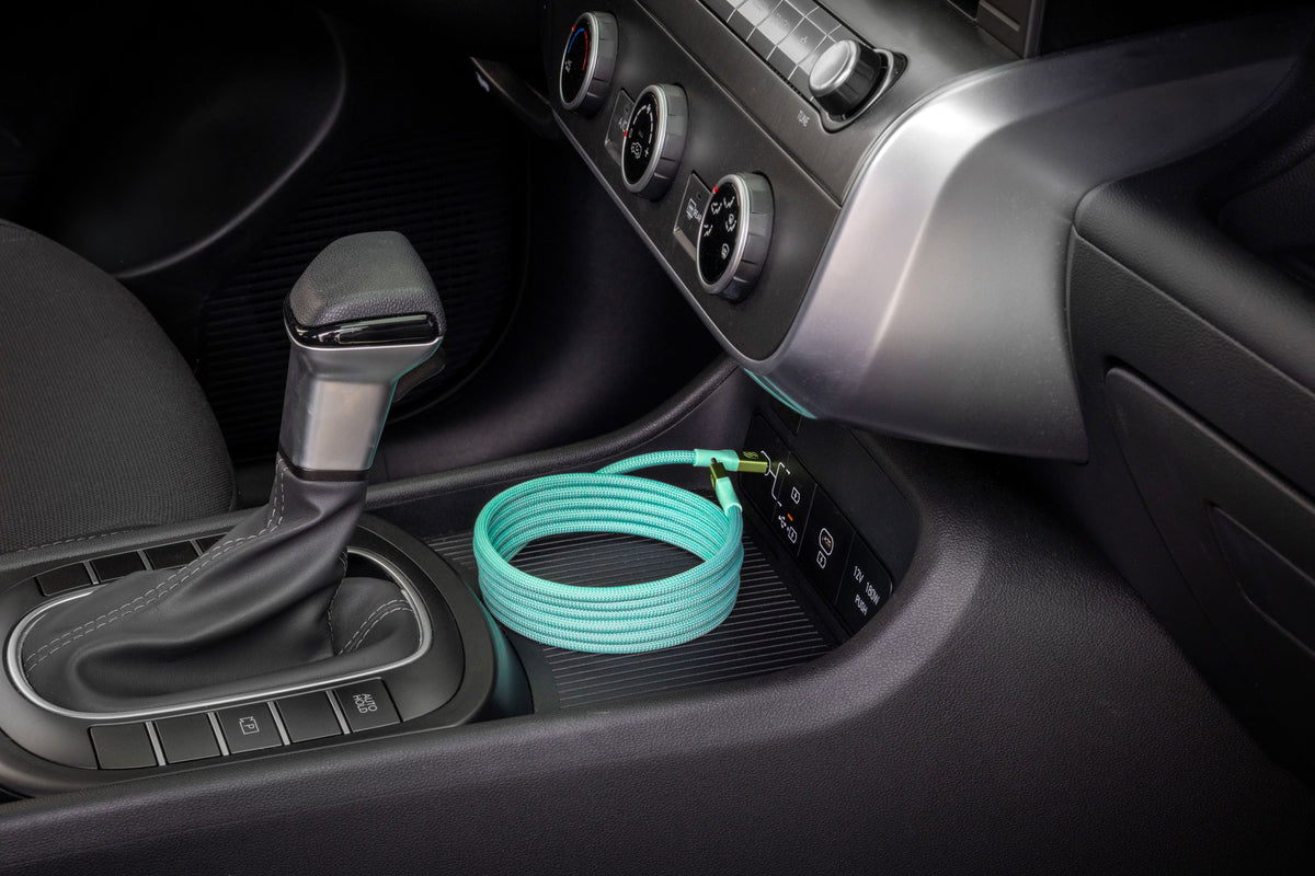 Green USB-C cable coiled in a car console