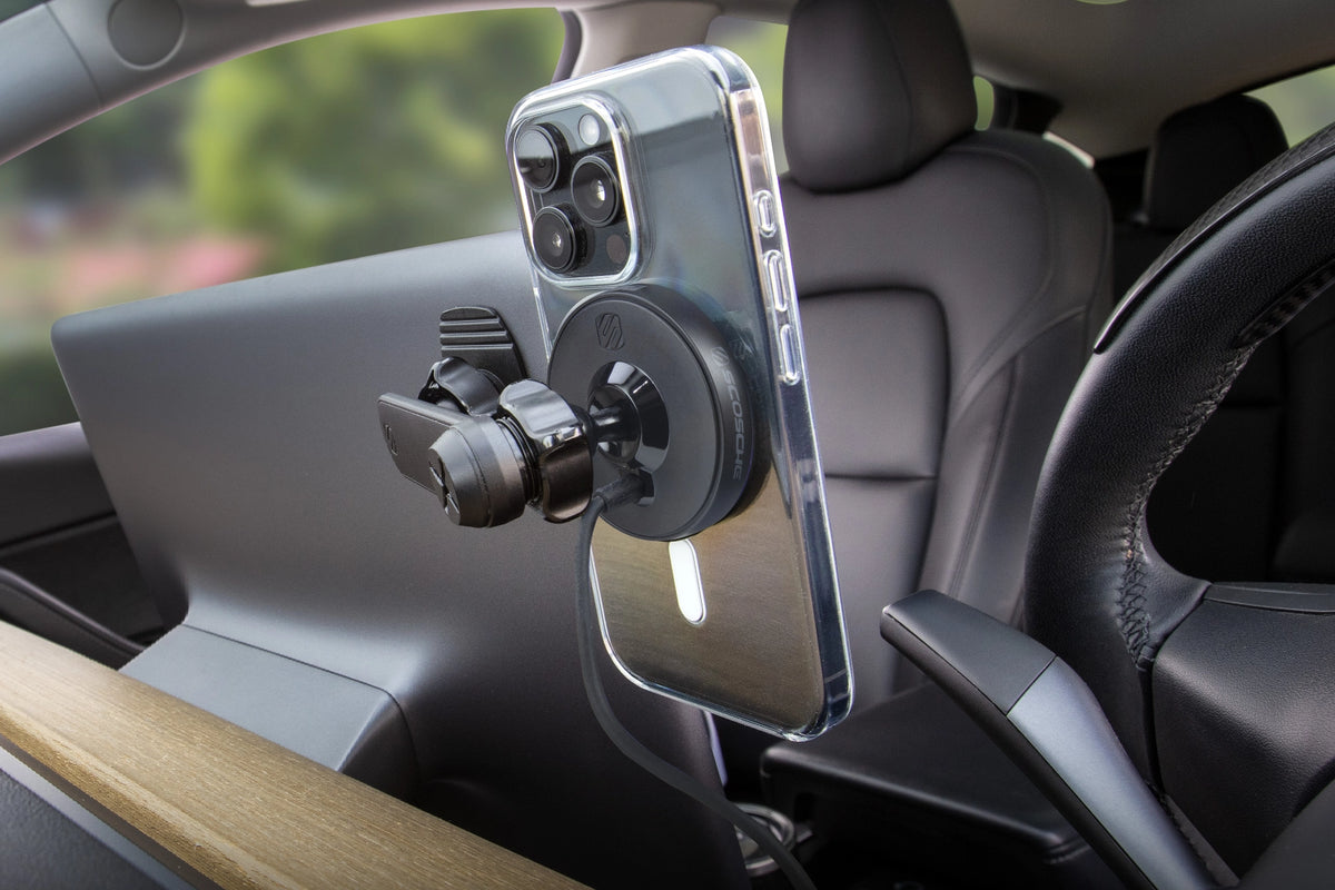 Rear view of an iPhone on a wireless charging magnetic phone mount attached to the back of a vehicle's display
