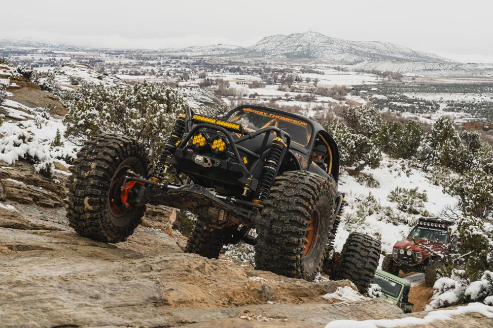 Offroad vehicles accending a hill in a pack