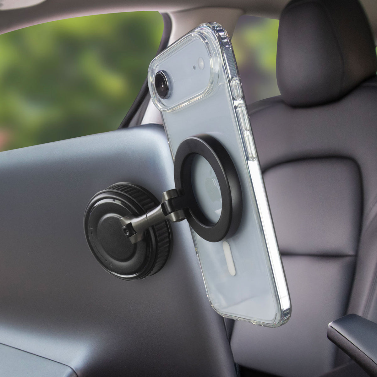 Phone mount attached to the back of a screen in a Tesla with an iPhone attached