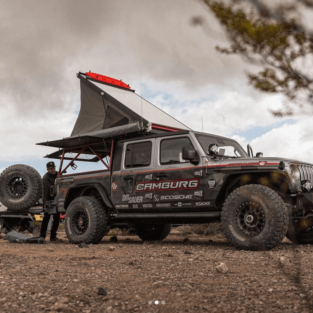 A custom Jeep from Camburg Racing has a pop-up tent open over the bed