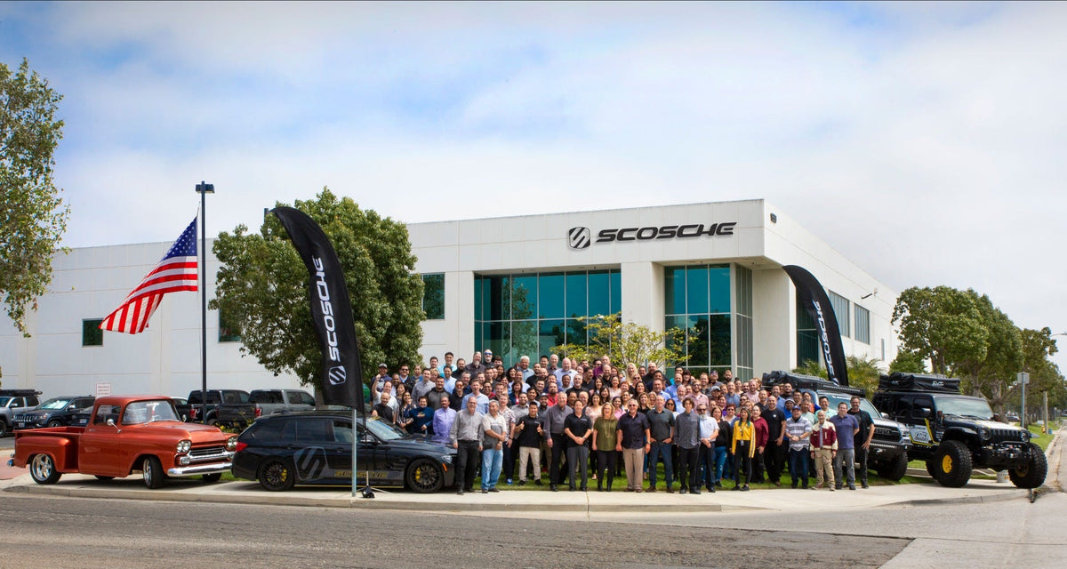 crowd gathered outside Scosche headquarter building with show cars on display