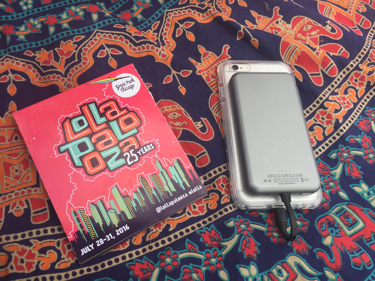 iphone charging via Scosche portable power bank next to program for Lollapalooza concert 2016