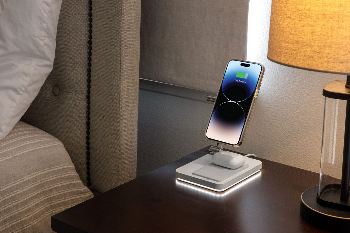 iphone charging via magnetic wireless charging stand sitting on bedroom side table
