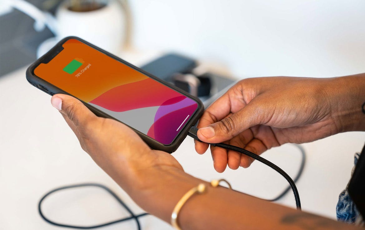 woman holding and charging iphone via Scosche cable