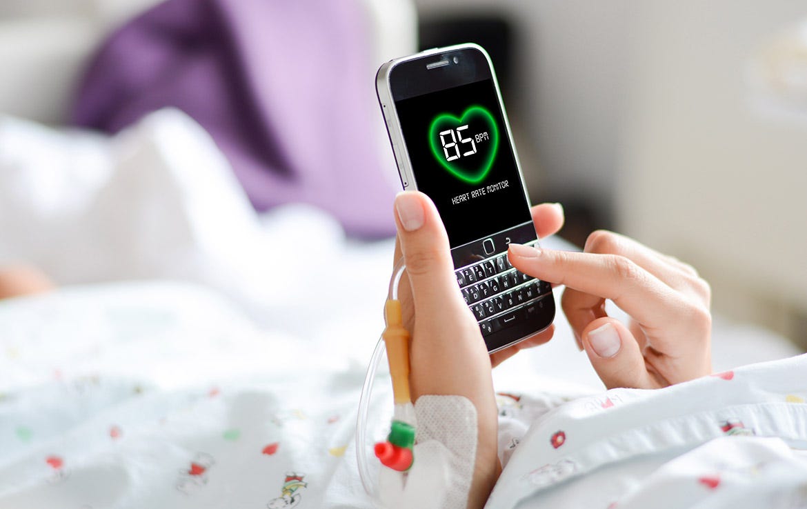 woman using phone in bed showing 85 BPM heart rate