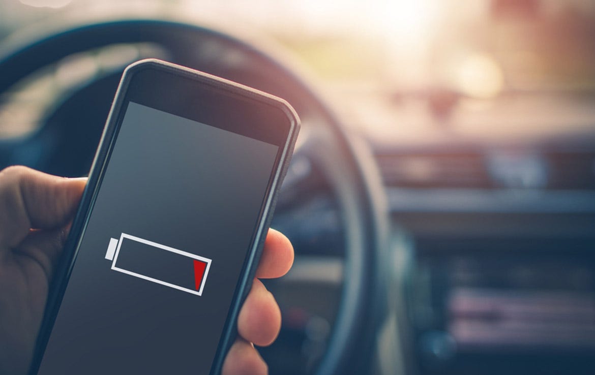 close up of man holding iphone with low battery alert on screen