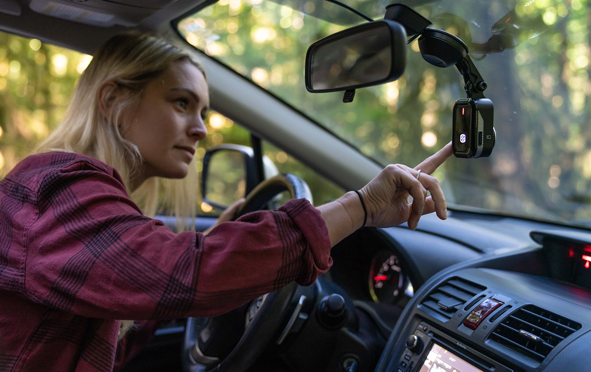 woman adjusting dash cam