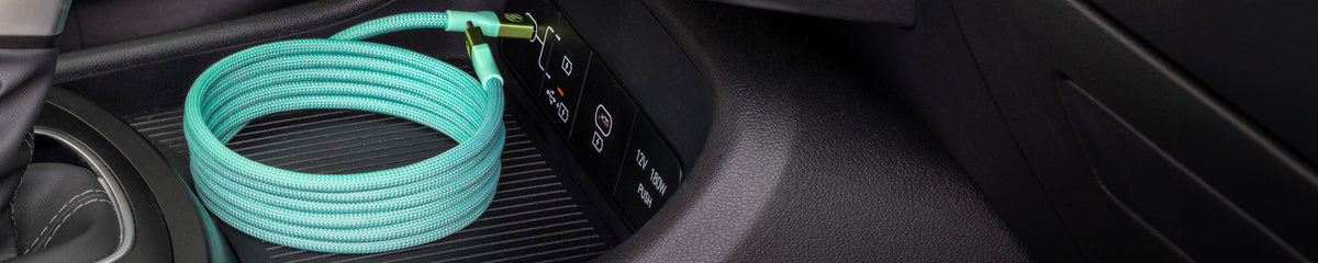 Green braided USB-C cable coiled up neatly plugged into a vehicle's USB-C port