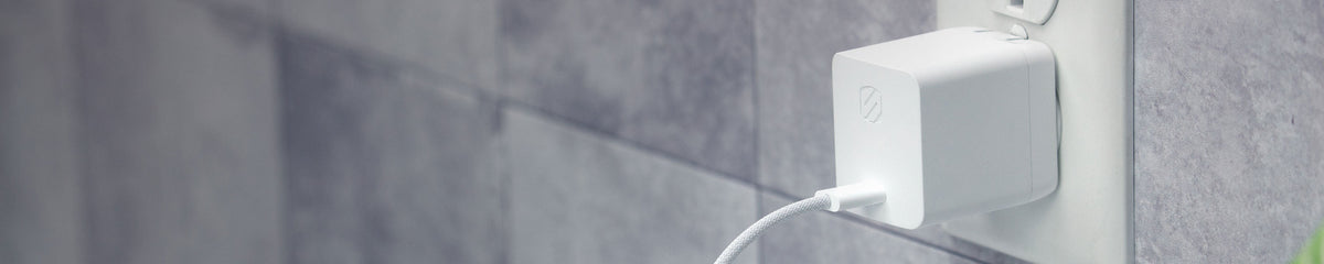 USB-C wall charger pluged into outlet with white cable attached