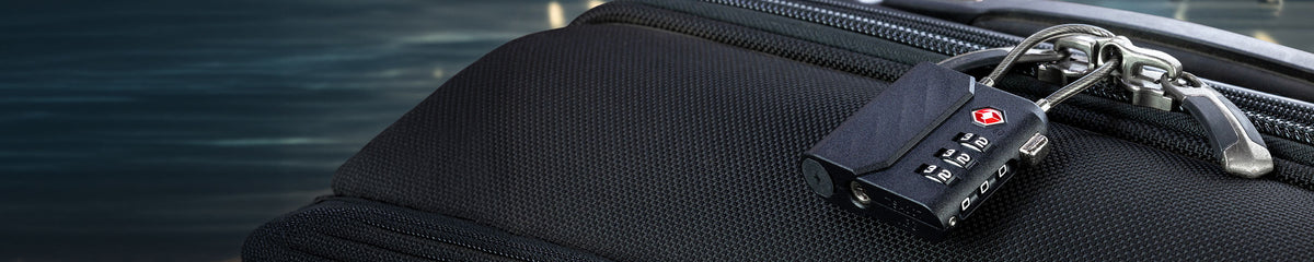 Luggage lock attached to a zipper on a suitcase