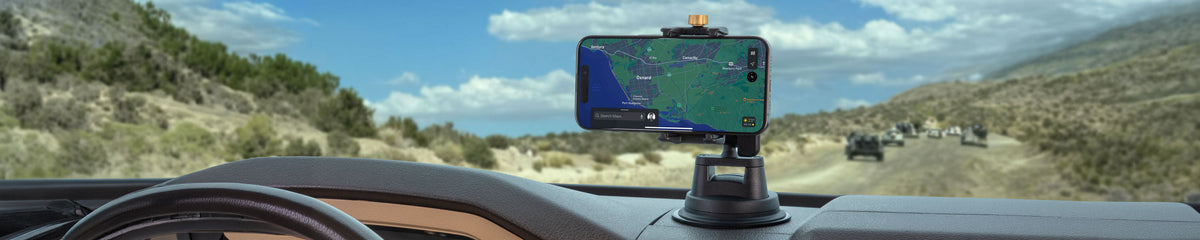 Phone mounted to dashboard with heavy duty mount on a dirt road