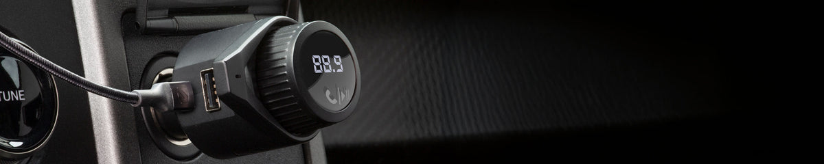 FM Transmitter plugged into a vehicle dashboard