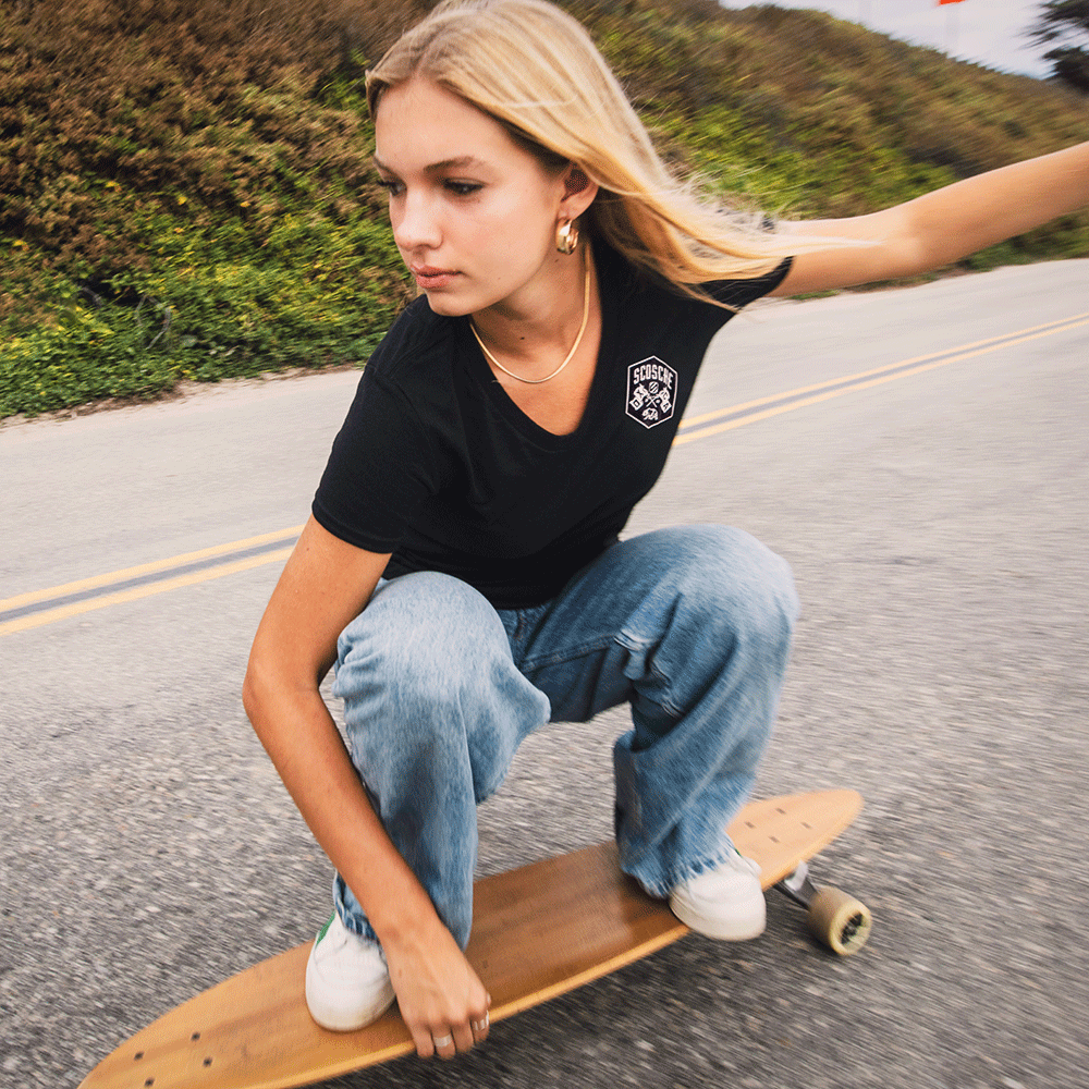 Woman skateboarding wearing Scosche Ladies' Tee with Bear Logo