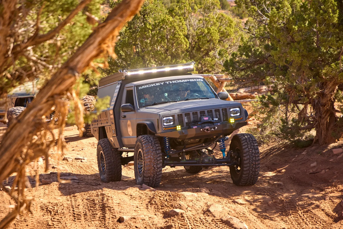 Jeep Commanche driving down a dirt road