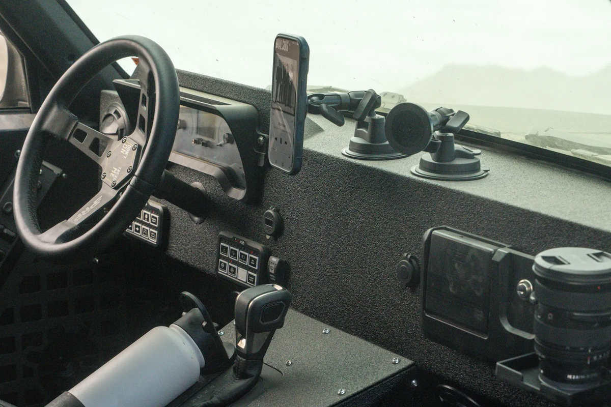 Interior of a Jeep Commanche with two phone mounts and one with an iPhone attached