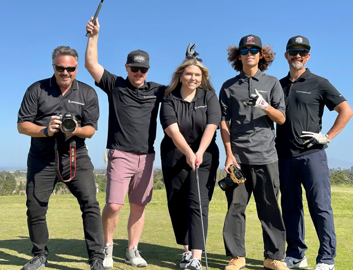 Group of people posing at a golf course