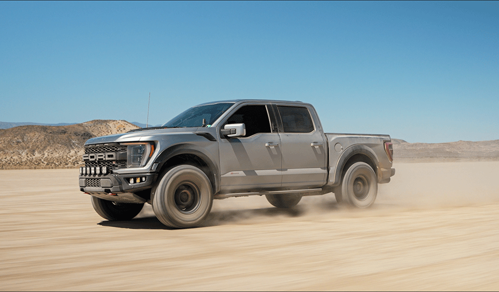 Ford F-150 Raptor driving at speed in the desert