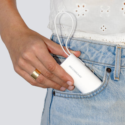 Power bank being tucked into a woman's pocket