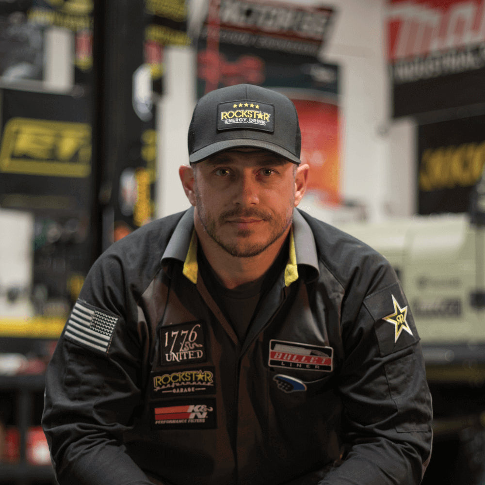 Man wearing black hat in garage setting