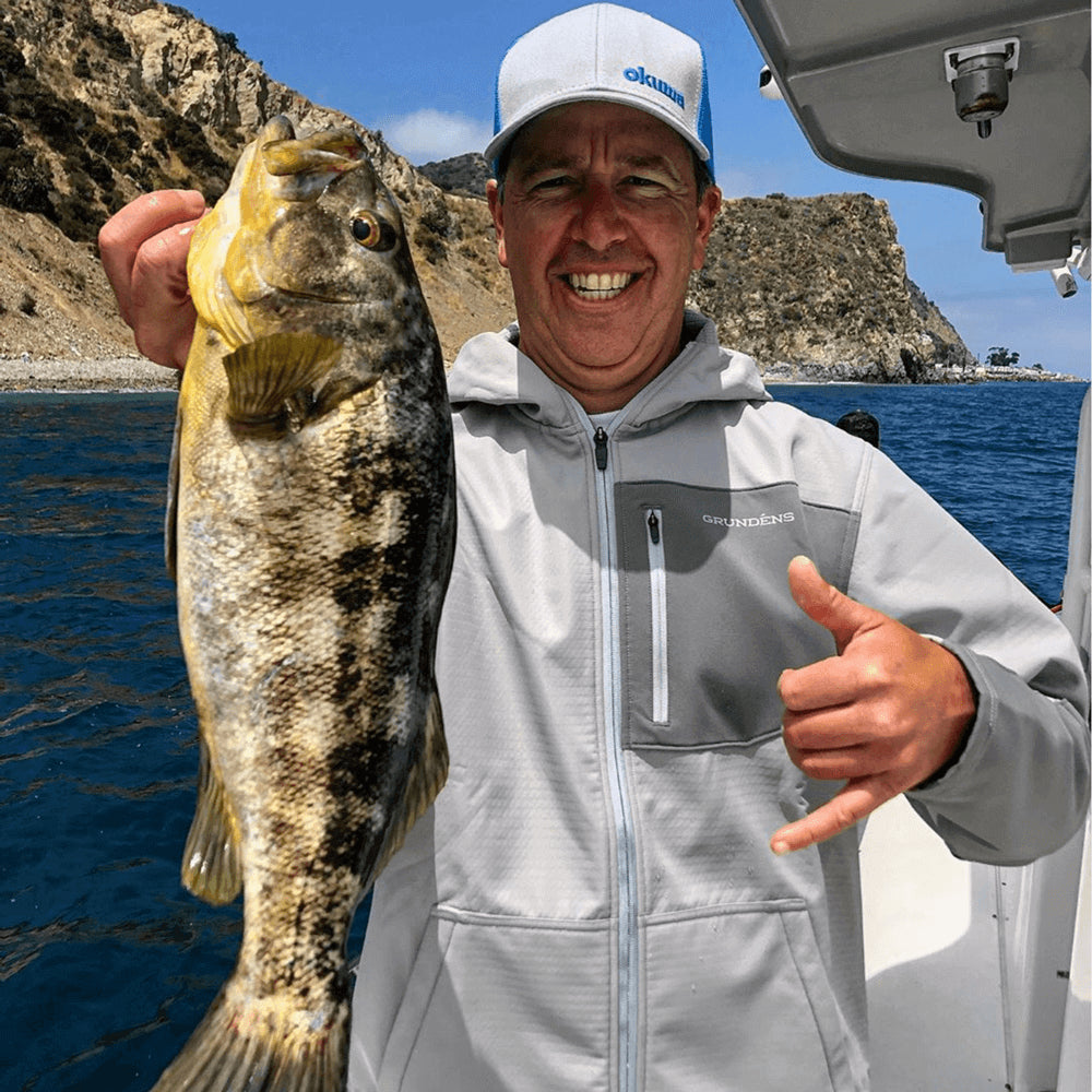 Man holding fish in one hand