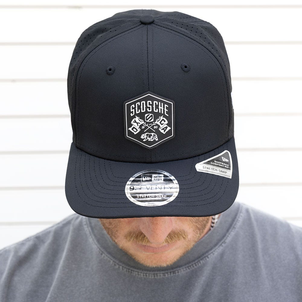 Man with head down to show black Scosche hat