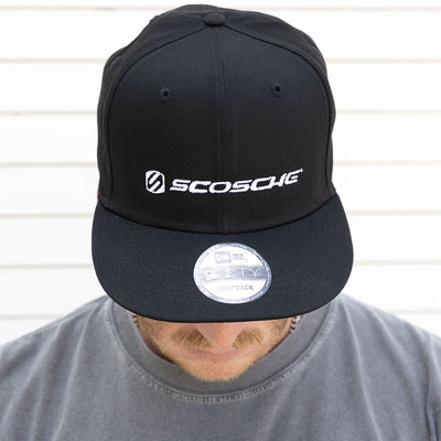 Man with head down to show black Scosche hat